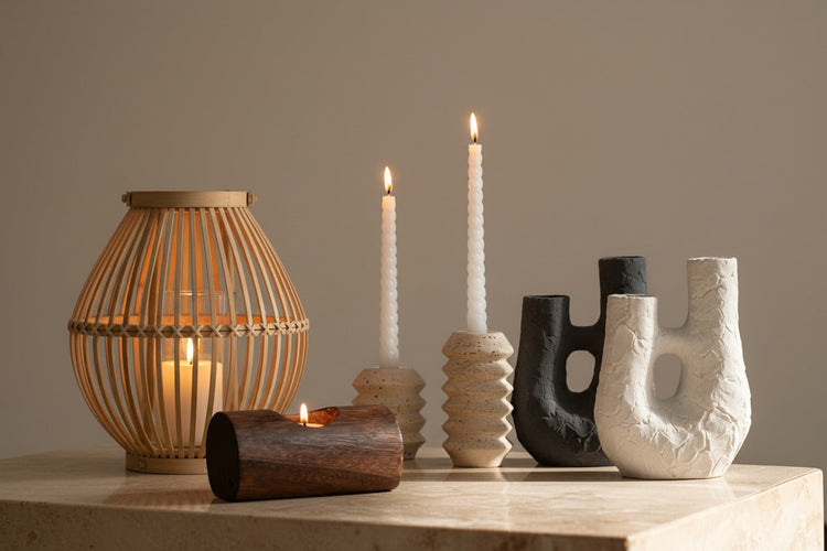 Candle holders in wood, travertine, bamboo and ceramic — taper holders, tea light holders, pillar stands and woven lanterns in Japandi and wabi-sabi styles. Natural materials, organic forms, designed for the quality of light they create.